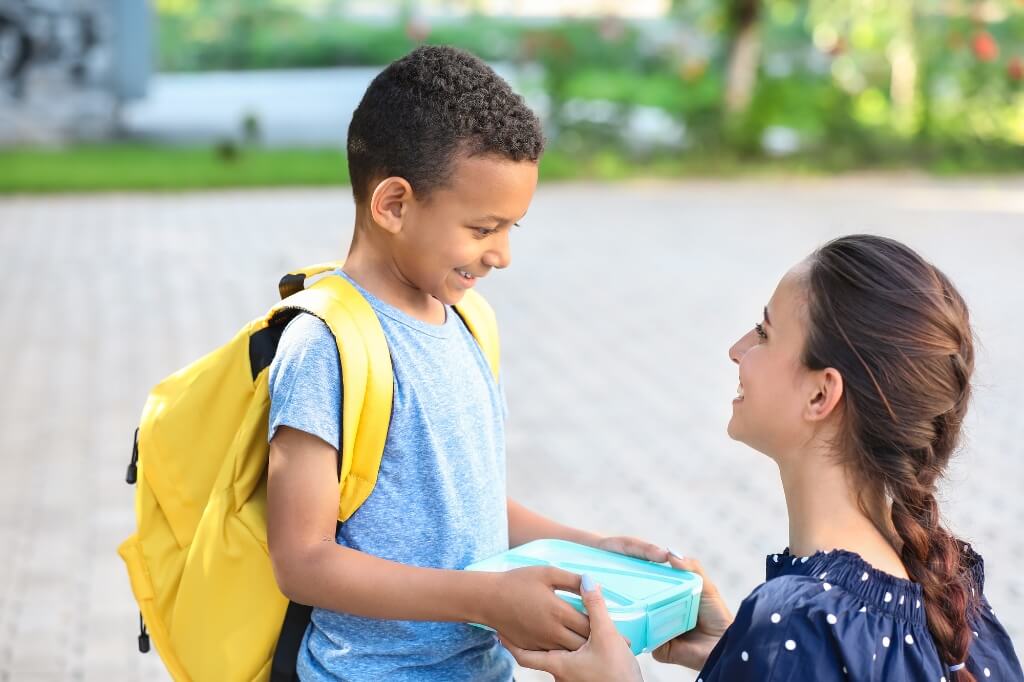 Smiling Student And Mom At School