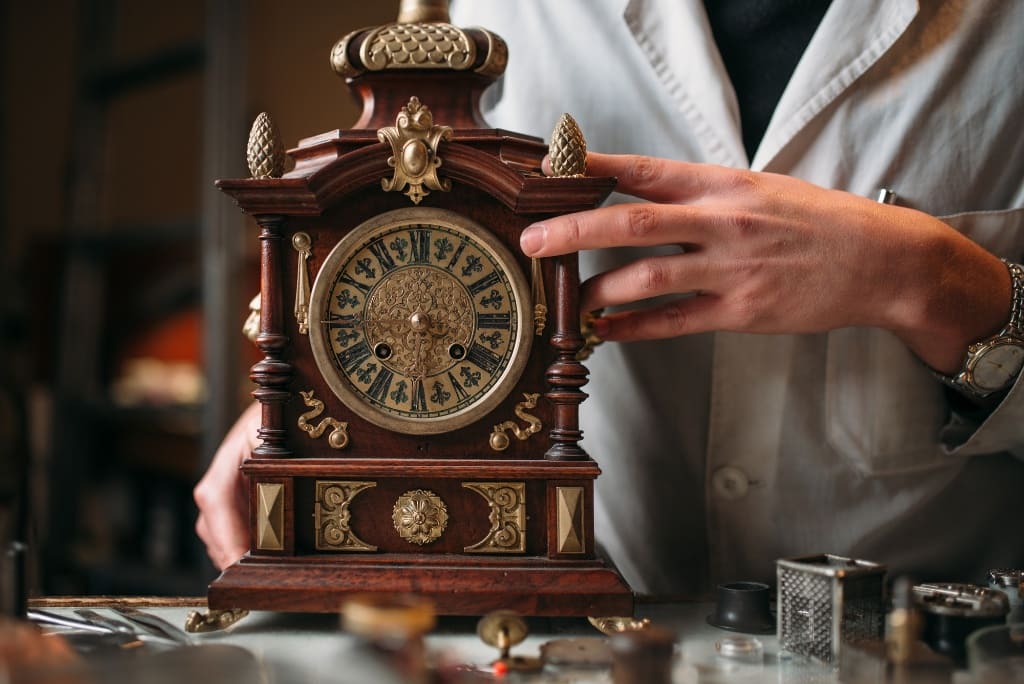 Man Holding Clock In His Hands